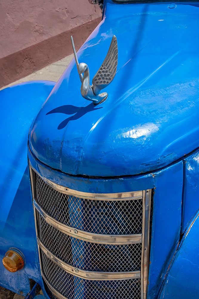 Detail of classic blue American car with chrome swan hood ornament in Trinidad-Cuba
